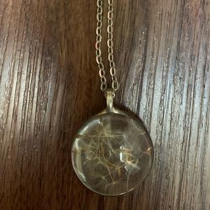 This is white dandelion hand crafted into glass.